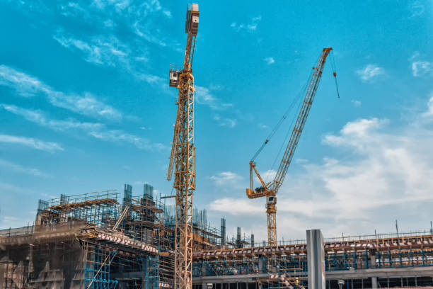 istock Lots of tower Construction site with cranes and building with blue sky background 985115032