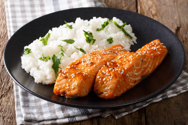istock Fried salmon in a honey-soy glaze and rice close-up. horizontal 985115132