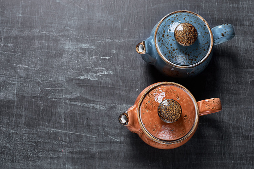 two teapots on a dark background. Traditional oriental tea drinking.