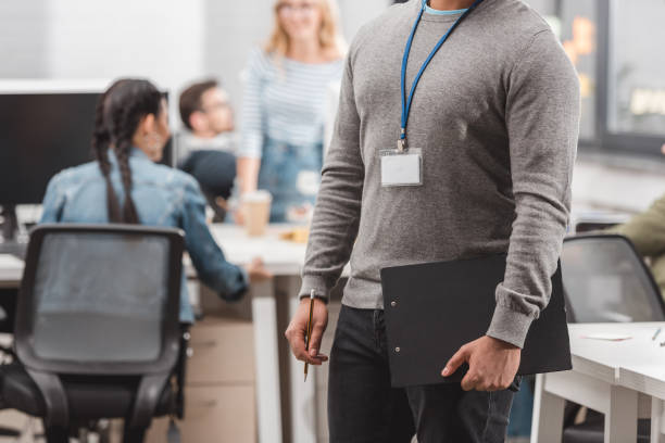 istock cropped image of african american with name tag and planchette at modern office 985125070