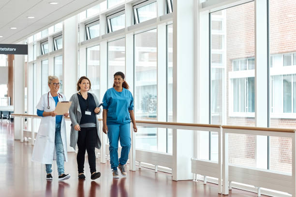istock Doctors And Nurse Walking In Hospital Corridor 985125984