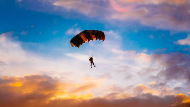 istock Low Angle View Of Man Paragliding Against Sky 985126282
