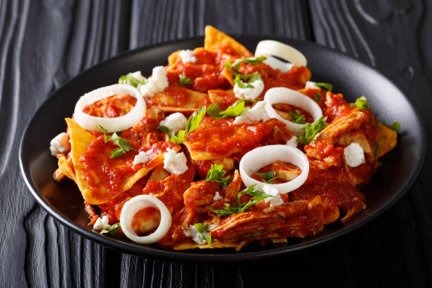 istock Homemade chilaquiles with chicken and tomato salsa closeup. horizontal 985129214