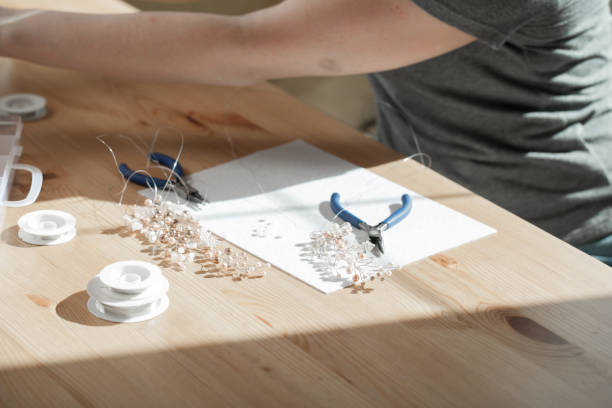 istock young woman makes jewelry 985129676