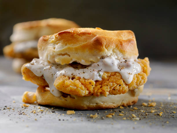 Fried Chicken Sandwich with Sausage Gravy on a Biscuit Fried Chicken Sandwich with Sausage Gravy on a Biscuit gravy photos stock pictures, royalty-free photos & images