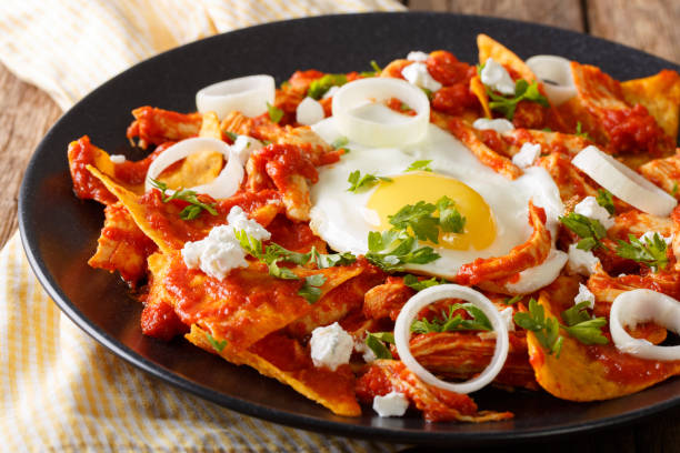 istock Tortillas with tomato salsa, chicken and egg close-up. horizontal 985132518