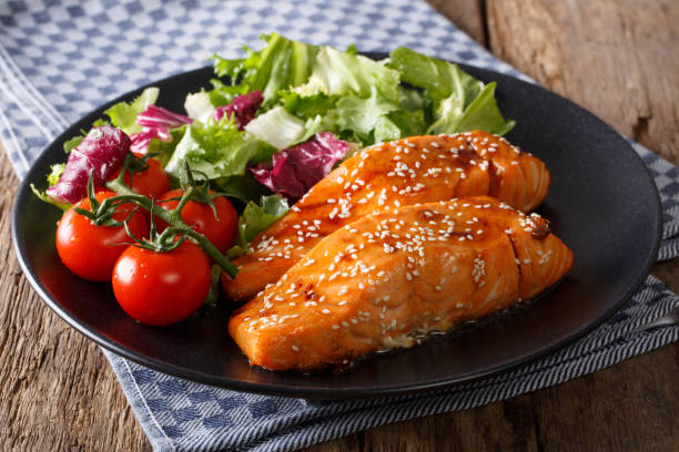 istock Spicy salmon with sesame seeds and fresh vegetables close-up. horizontal 985134158