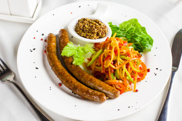 istock Bavarian grilled sausages with fresh vegetables spaghetti 985144422
