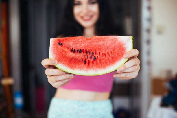 istock Woman eating watermelon 985146902