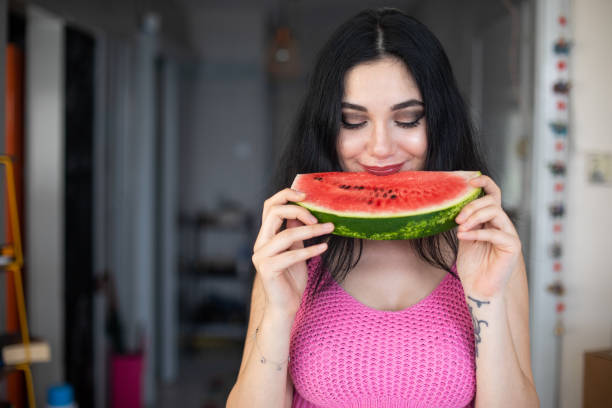 istock Woman eating watermelon 985146906