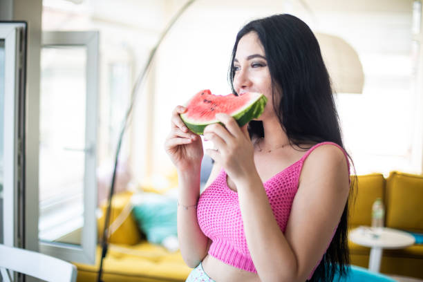istock Woman eating watermelon 985146956