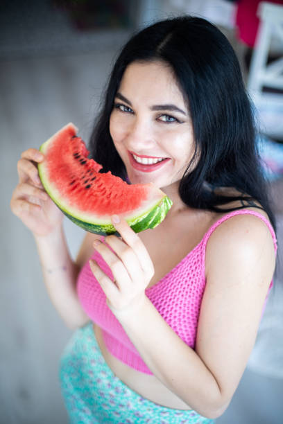 istock Woman eating watermelon 985147538