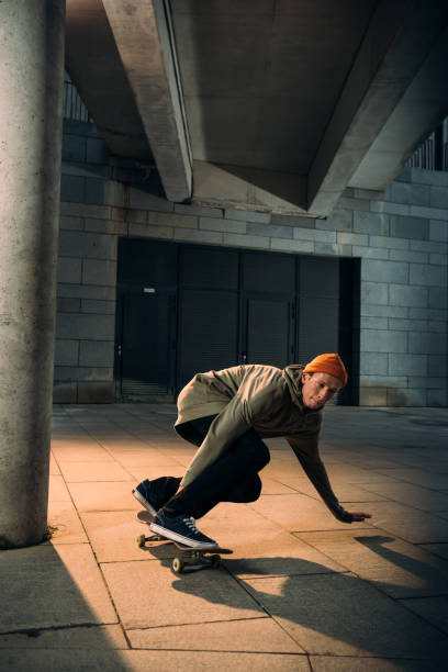 istock handsome young man riding skateboard 985151050