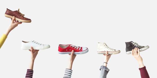 istock Hands holding colorful canvas shoes 985154562