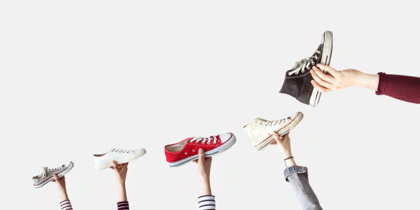 istock Hands holding colorful canvas shoes 985154918