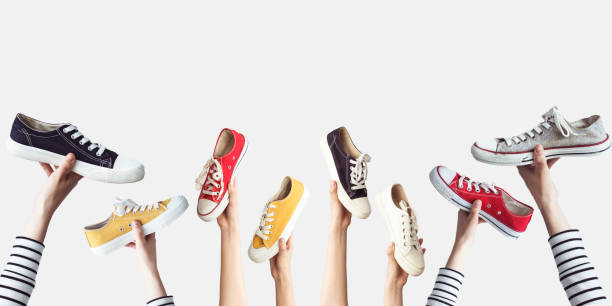 istock Hands holding colorful canvas shoes 985154922