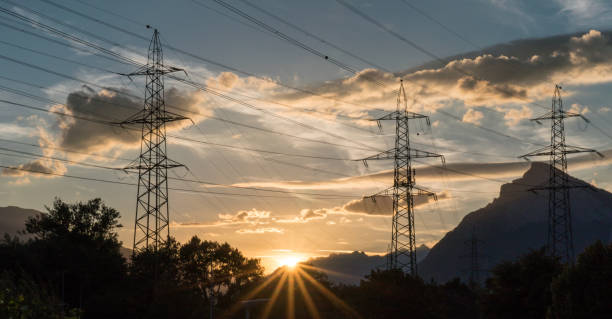 istock sunset in a mountain landscape with electrical power lines and masts in the foreground 985155042