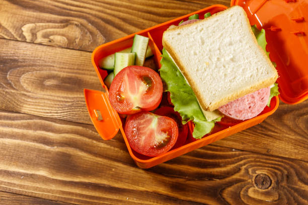 School lunch box with sandwich and fresh vegetables on wooden table School lunch box with sandwich and fresh vegetables on wooden table. Top view 2632 stock pictures, royalty-free photos & images