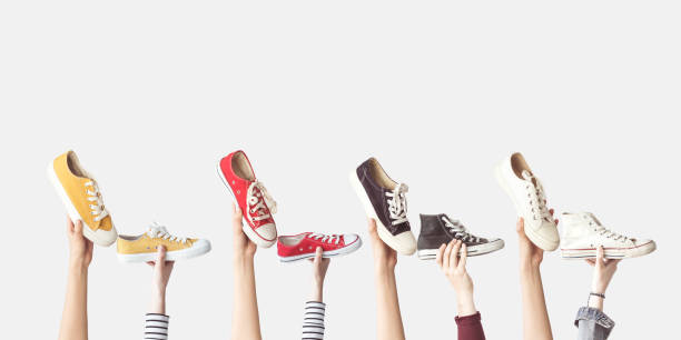 istock Hands holding colorful canvas shoes 985155472