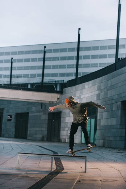 istock professional skateboarder balancing with board on bench in urban location 985155612