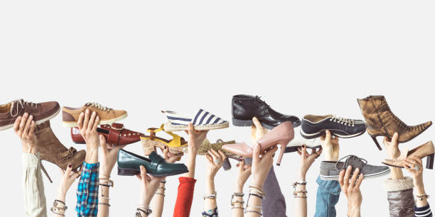 Hands holding different shoes on isolated background Hands holding different shoes on isolated background man and woman differences stock pictures, royalty-free photos & images