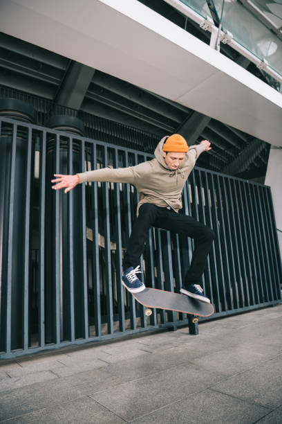istock professional skateboarder performing trick in urban location 985155732