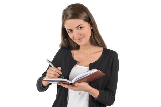 istock Beautiful office woman writing on her agenda 985158252