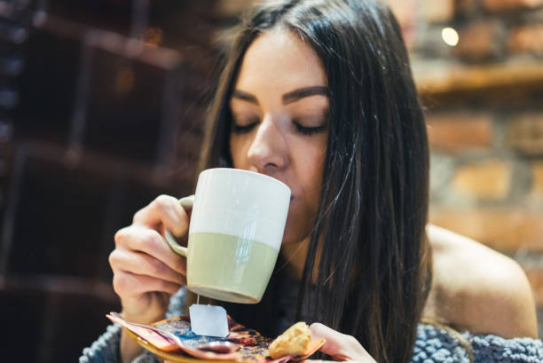 istock Brunette girl in cafe with hot drink 985158762