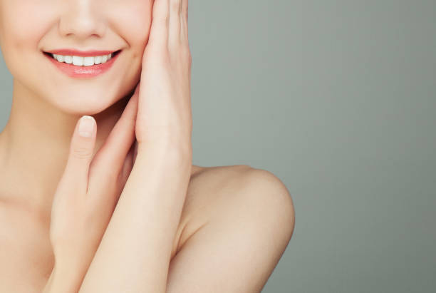 istock Perfect Female Smile with White Teeth on Grey Background 985159082