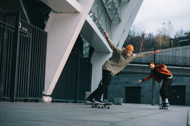 istock young men riding skateboards in urban location 985162292