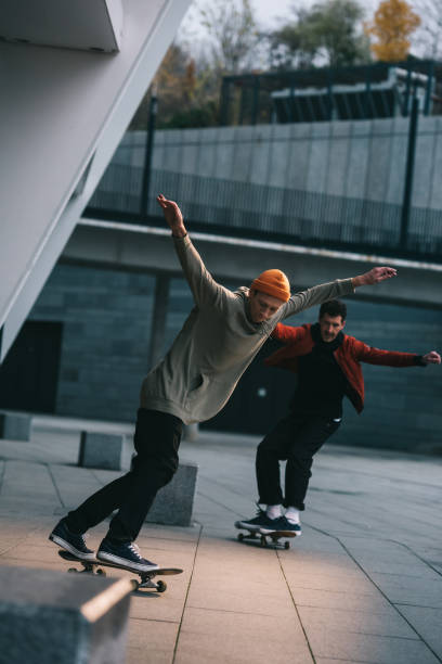 istock young men riding skateboards in urban location 985162536