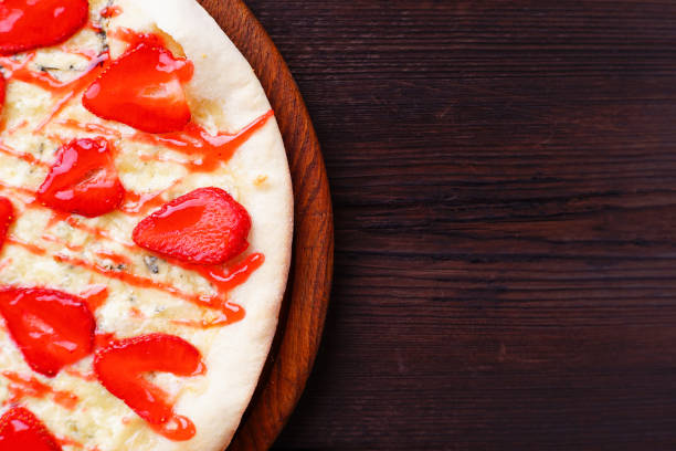 istock strawberry pizza background with free space 985166068