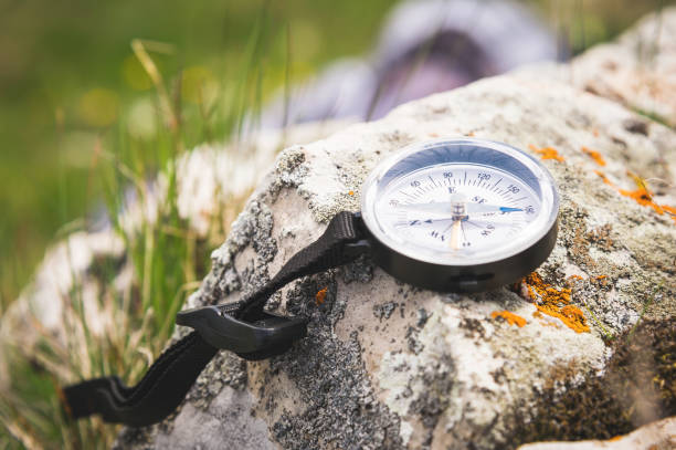 istock A magnetic compass lies on a stone next to the grass 985169590