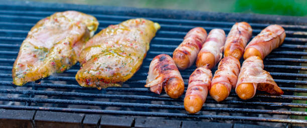 istock Assorted mixed grill from chicken meat, and pork, sausages  roasting on barbecue grid cooked for summer family dinner 985170448