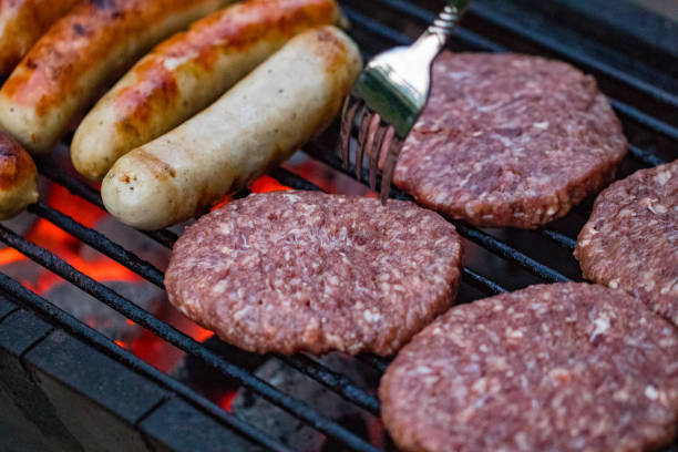 istock Assorted mixed grill from chicken meat, and pork, sausages  roasting on barbecue grid cooked for summer family dinner 985170694