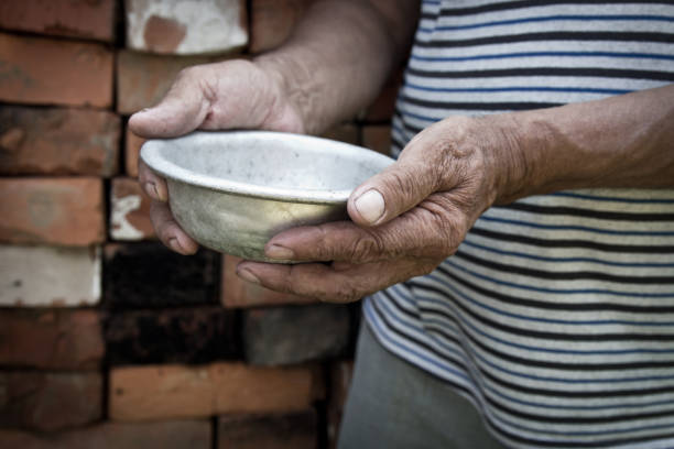 istock The poor old man's hands hold an empty bowl. The concept of hunger or poverty. Selective focus. Poverty in retirement.Homeless. Alms 985170700