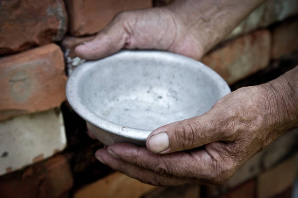 istock The poor old man's hands hold an empty bowl. The concept of hunger or poverty. Selective focus. Poverty in retirement.Homeless. Alms 985170932