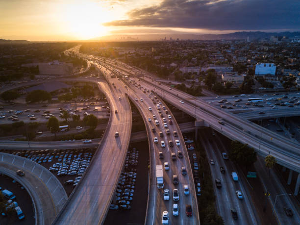 Drone Shot of 10/110 Interchange at Sunset Drone shot of the I-10 / I-110 Interchange on the edge of Downtown Los Angeles at sunset. traffic stock pictures, royalty-free photos & images