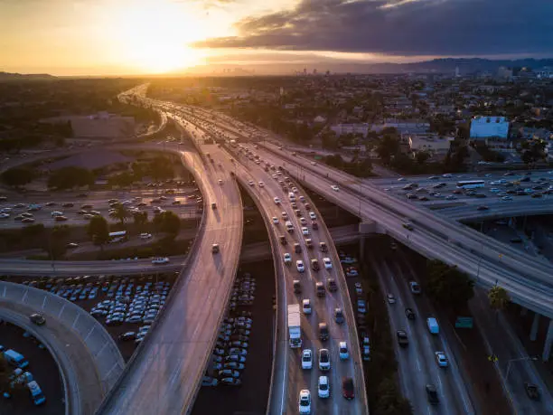 Drone shot of the I-10 / I-110 Interchange on the edge of Downtown Los Angeles at sunset.