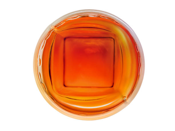 Whiskey in glass from top on white background