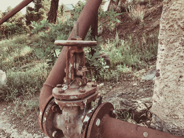 istock A valve connecting two large iron pipes. Close up shot 985174686