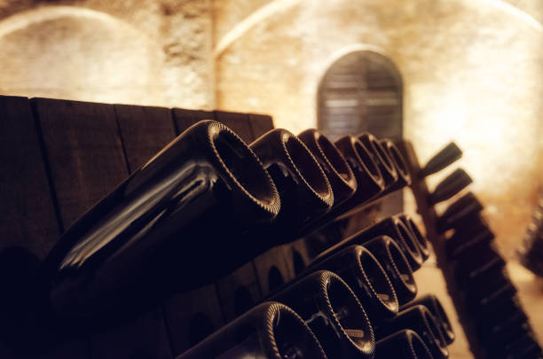 Pupitre and wine bottles inside an underground cellar stock photo