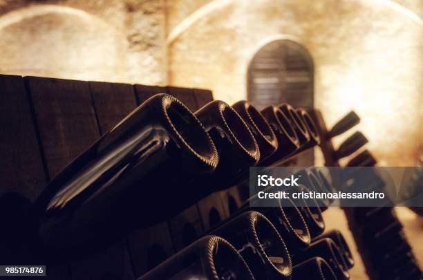 Pupitre And Wine Bottles Inside An Underground Cellar Stock Photo - Download Image Now