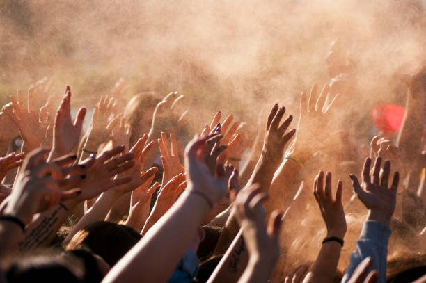 Crowded people hands up Crowded people hands up at a day time concert. revolution stock pictures, royalty-free photos & images