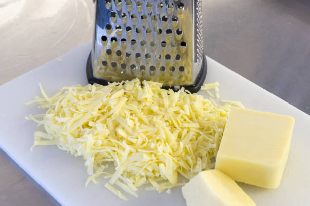 istock Grated cheese and grater on 985187926
