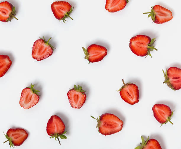 istock Halves of strawberries on the white background. 985188746