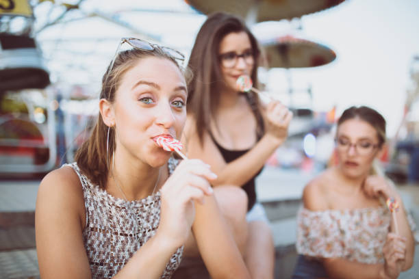 istock Girls fooling around with lollipops 985191572