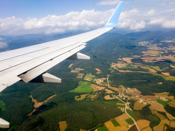 istock Wing of an airplane flying 985191604