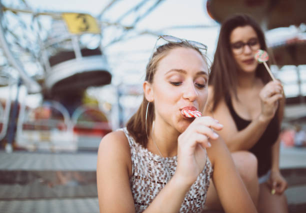 istock Girls fooling around with lollipops 985230788