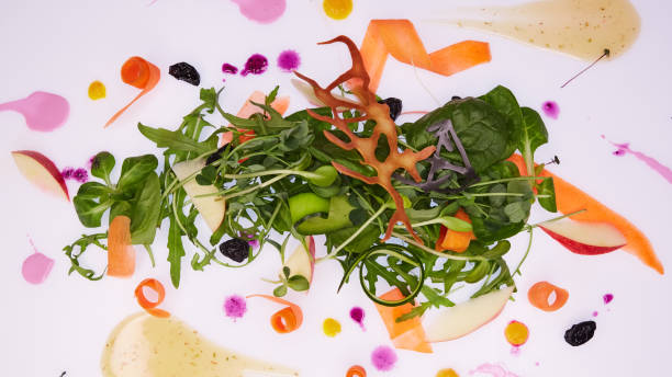 istock Mix fresh leaves of arugula, lettuce, spinach, beets for salad on a white background. Selective focus 985232196